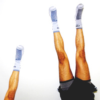 2 sets of the same legs doing a handstand in front of a white wall.