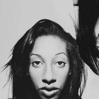 3 heads of the same woman making different expressions next to each other. One head is upside down.