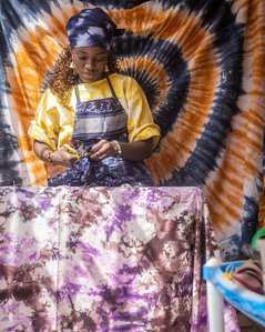 Kemi Alaro, tieing a fabric for a design. January, 22 2022. Abuja, Nigeria.