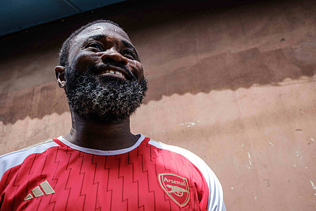 LAGOS, NGA - April 28, 2024: Portrait of Adeshina Mayowa Karonwi; 45, in Festac during the second half time out of Arsenal vs Totteham match. Mayowa has been a supporter of Arsenal since 1994. CREDIT: Taiwo Aina for New York Times.
