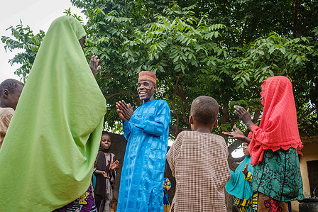 YOLA, NGA - October 5, 2023: Salihu Yahaya plays with his children at home in Dasin Hausa community, Fufoire LGA, Adamawa State Nigeria. Salihu Yahaya is a beneficiary of climate resilency project. CREDIT: Taiwo Aina for IRC