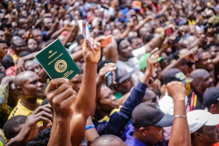 LAGOS, NGA - FEBRUARY 11, 2023: One of ObiÕs supporters shows his international passport as his form of identity to support Peter Obi during the ongoing rally on February 11, 2023 at Alaba market, Lagos, Nigeria.  CREDIT: Taiwo Aina for The New York Times