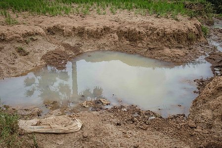 KADUNA, NGA - August 9, 2023: A climate eroded affected land are close to the road link bridge at Kabaya community, Soba LGA, Kaduna state, Nigeria. “I find it very difficult to cross that bridge to school. Sometimes when it over flows, we are left with n