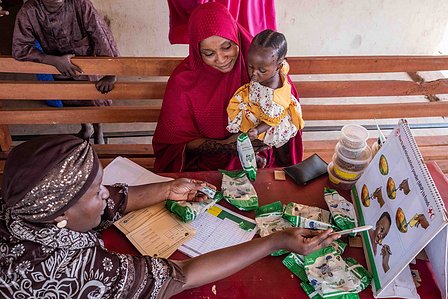 SOKOTO, NGA - July 3, 2023: Rachael Samaila, a Unicef nutritionist explains the use of micronutrient powder to Safiya Abubakar; HafsatÕs mother at Gidan Igwai Primary health center, Sokoto North LGA, Nigeria. CREDIT: Taiwo Aina 