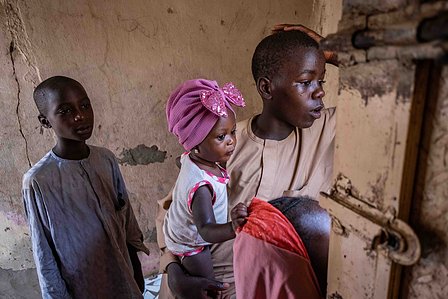 SOKOTO, NGA - July 3, 2023: Nana Firdausi Umar carried by her uncle in her home at Jiddawa community of Rumbukawa, Sokoto North LGA, Nigeria. CREDIT: Taiwo Aina 