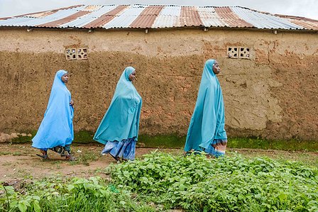 KADUNA, NGA - August 11, 2023:  Asiya Ja’afar and her friends walk home after poultry lessons at Anguwan Malamai, Zaria, Kaduna State, Nigeria. CREDIT: Taiwo Aina