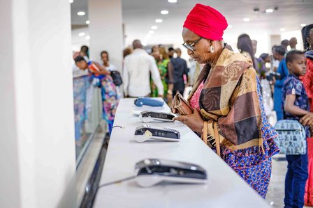 LAGOS, NGA - FEBRUARY 12, 2023: Church member pays her offering using displayed Point-Of-Service payment units on February 12, 2023 in Global Citadel Community Church, Lagos, Nigeria. Churches now receive tithes and offerings digitally, there is no much c