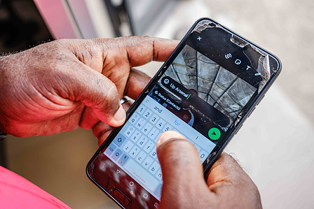 LAGOS, NGA - April 28, 2024: Adeshina Mayowa Karonwi; 45, in Festac updates his WhatsApp status after the second half time out of Arsenal vs Totteham match. Arsenal won the game as final score was 2-3 to Totteham. Mayowa has been a supporter of Arsenal si