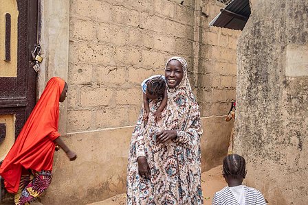 SOKOTO, NGA - July 4, 2023: Maryam Musa carries AsmÕu Kasimu outside their home at Kofar Marke, Sokoto North LGA, Nigeria. CREDIT: Taiwo Aina 