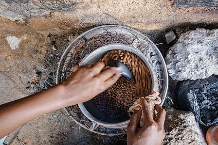 KADUNA, NGA - August 12, 2023: Asiya Sa’idu processing her tigernut snack in her home kitchen at Dogon Bauchi, Sabon Gari, Kaduna State, Nigeria. “I told my father that I want to start a business so that I can be supporting my education so he gave me. He 