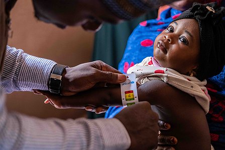 SOKOTO, NGA - July 5, 2023: Mr Bello Hassan; a nutrition officer takes Nana FirdausiÕs MUAC at Rumbukawa Primary Health Care center, Sokoto state, Nigeria. CREDIT: Taiwo Aina 

