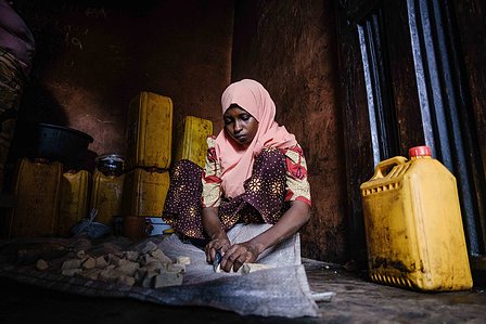 KADUNA, NGA - August 9, 2023: Shafa’atu Nuhu, 22, cutting chin chin in her home at Kabaya community, Soba LGA, Nigeria. “I sell flour and together with my co- wives we do this chin-chin business, we fry it all day and people come even from neighboring com