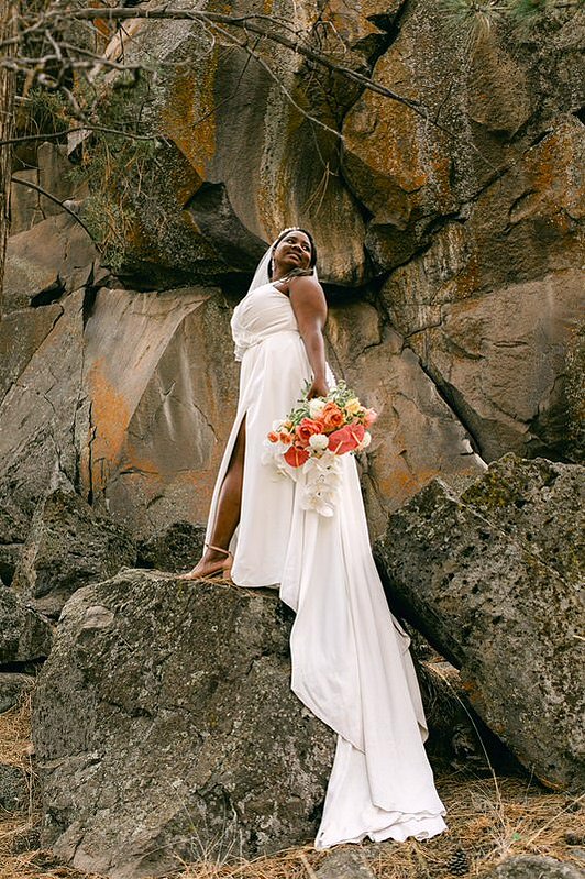 stunning bride posing for her bend oregon wedding photographer at the riverhouse lodge located by the deschutes river