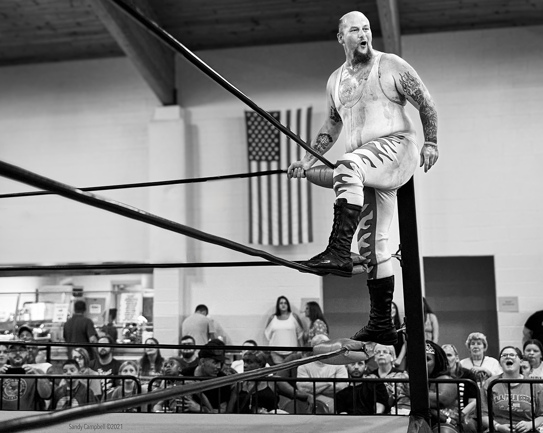Whipping the crowd into a frenzy just before the wrestling match. 