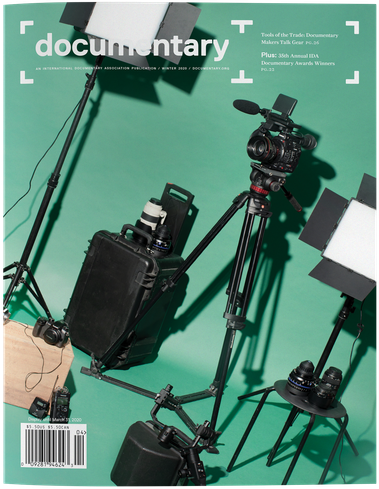 Cover of Winter 2020 issue of Documentary magazine, dedicated to nonfiction film and audio culture with photo of filmmaking gear, travel hard case, lights, cinecamera, tripods, mirrorless camera. Creative direction by Susan Yin and photo by Maggie Shannon