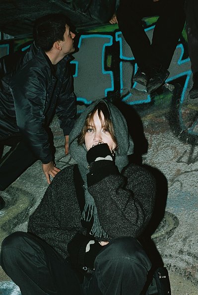 A girl sits on the side of a storm drain tunnel at an illegal rave-Laszlo Locsei Melbourne Nightlife and Music Rave photographer documentary photography, events photography