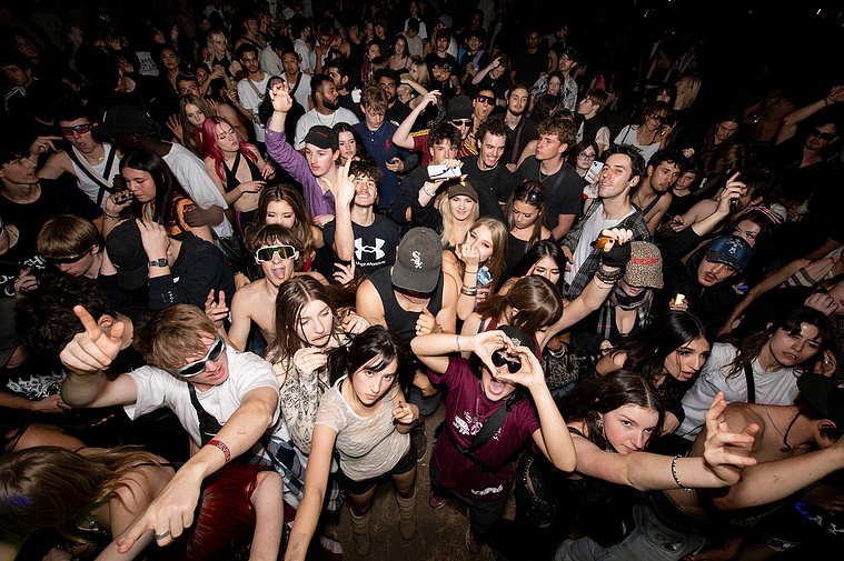 A wide angle shot of an energetic crowd of young people at a rave in melbourne-Melbourne nightlife and events photography music photography party photos
