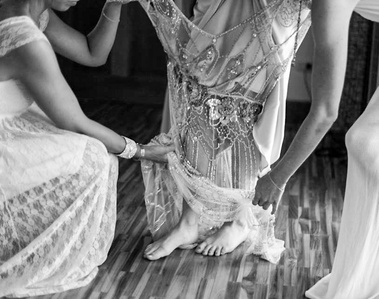 Bride getting into dress. black and white photo