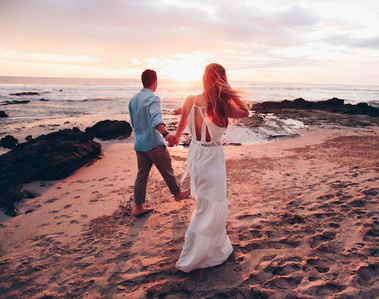 Bride and groom at the beach during sunset. Destination wedding. 
