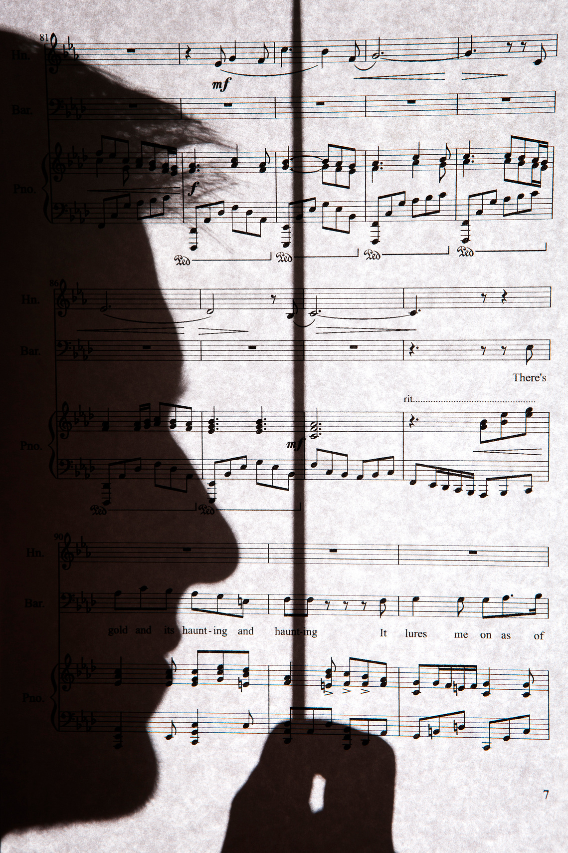 Black Hills State University student Jesse Dunaway poses in front of a page of sheet music for his five-movement musical composition called 