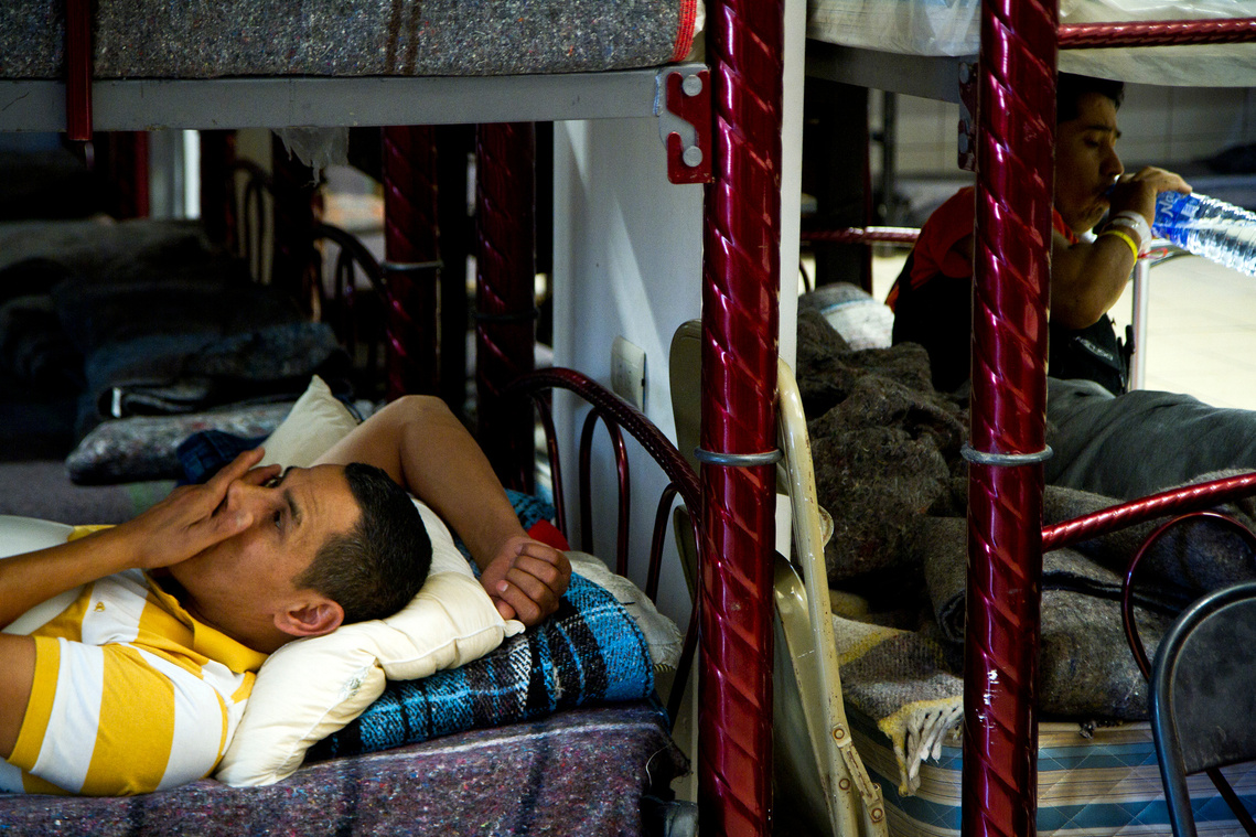 Sergio Silva Rodriguez, left, and Francisco Javier Ramos Martinez, two deported migrants, rest in adjacent bunk beds at the Albergue San Juan Bosco migrant shelter in Nogales, Sonora on October 18, 2012. 