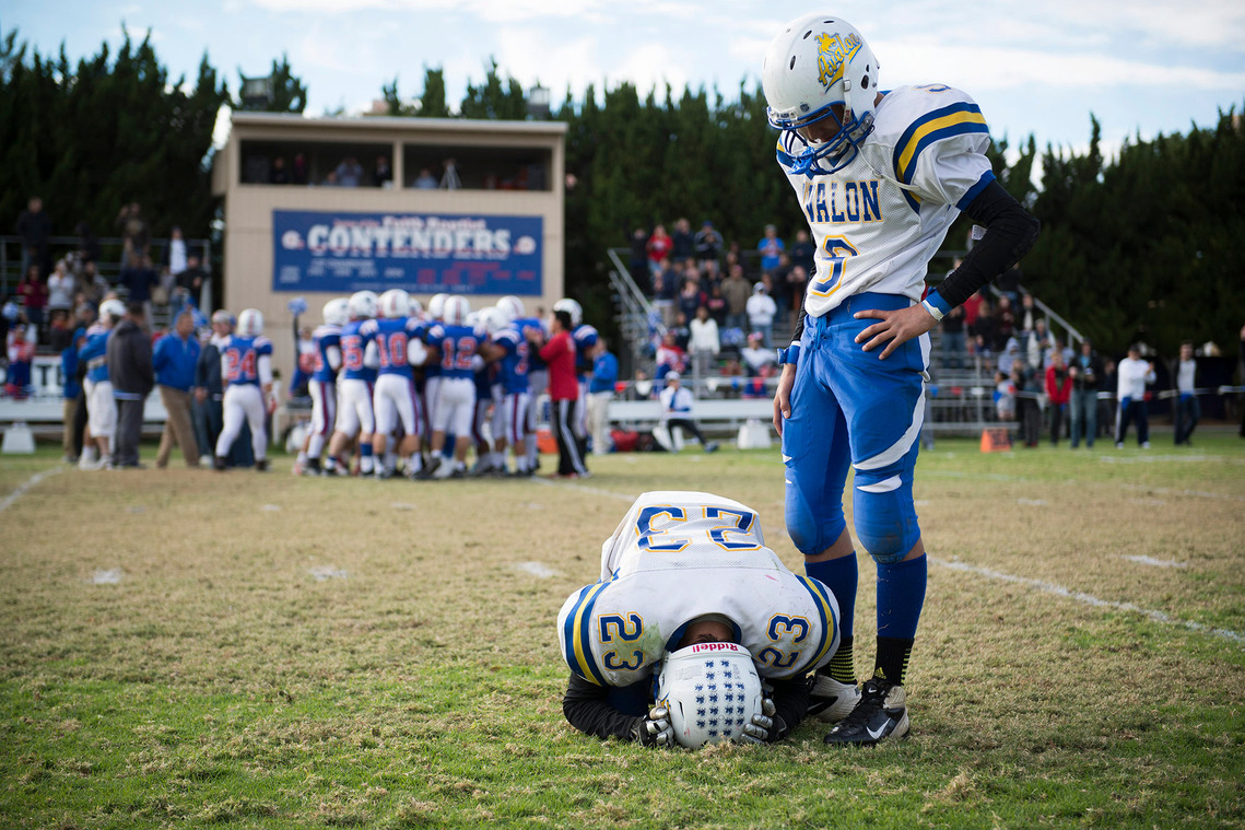 Avalon's Cesar Ventura, right, comforts teammate David Castro-Jimenez after their team lost Saturday's CIF-SS Division 1 eight-man semifinal game against Faith Baptist at Faith Baptist. 