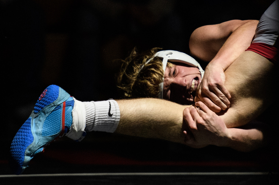 Hillcrest’s Thomas Snipes grabs Eastside’s Lane Schrader by the leg as he attempts to take him down during their meet Thursday, Jan. 13, 2022.