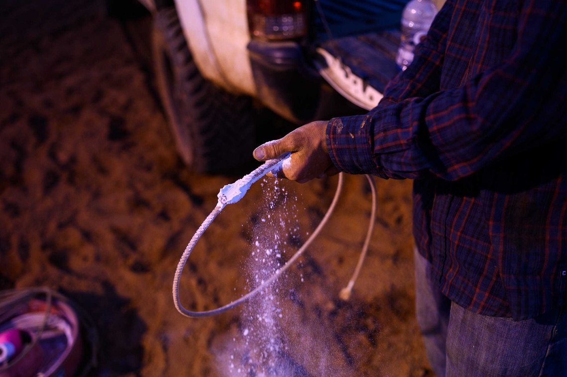 Reign Dobbins spreads chalk across his rope before starting roping practice at J Rest Farm Thursday, April 22, 2021.