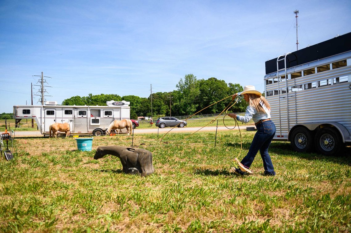 Sally Poteat practices her roping near her trailer before competing in a rodeo at the Crescent High School FFA Arena Saturday, May 1, 2021.