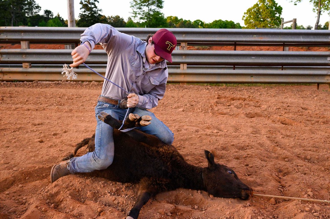 Colton Schlock practices roping a calf at J Rest Farm Thursday April 22, 2021.