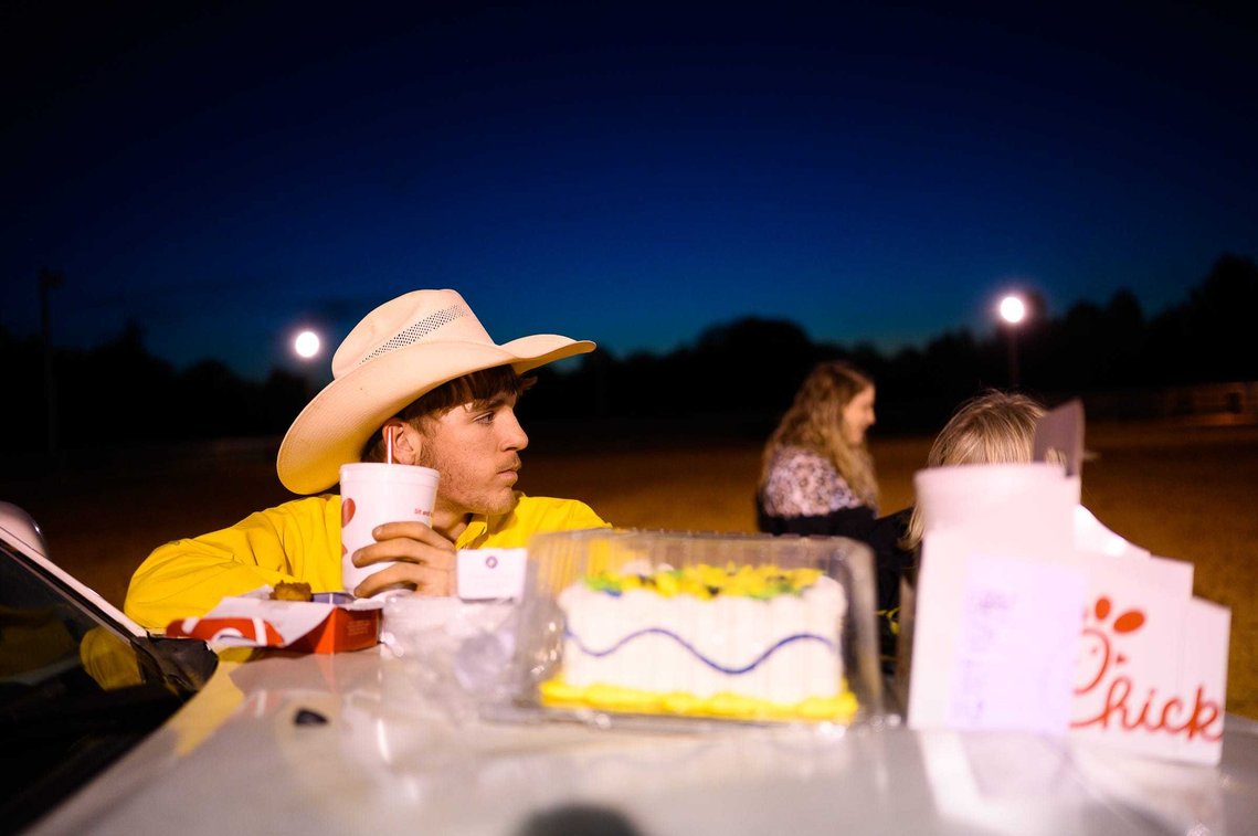 Reign Dobbins leans on the hood of a truck as he and loved ones celebrate his 17th birthday at J Rest Farm Thursday, April 15, 2021.