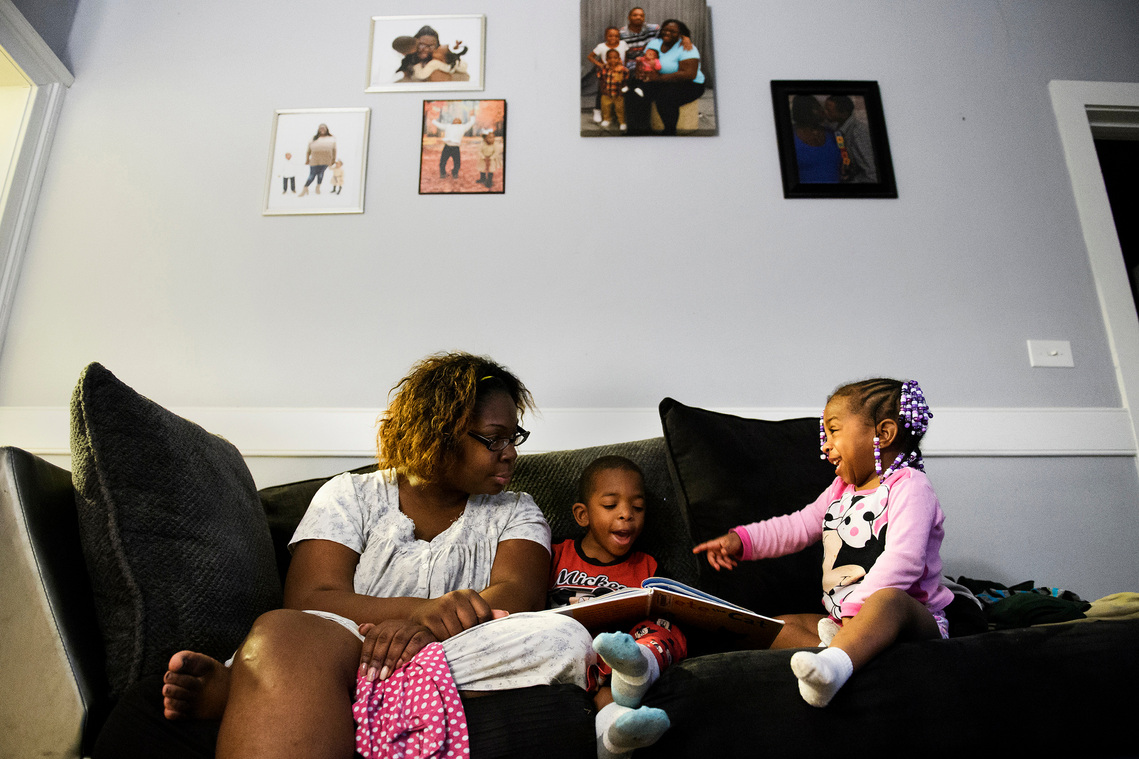 Tiffany Copeland reads a book with her son, Jermier, 6, and daughter Jenilya, 3, inside her home Monday, Dec. 17, 2018. 