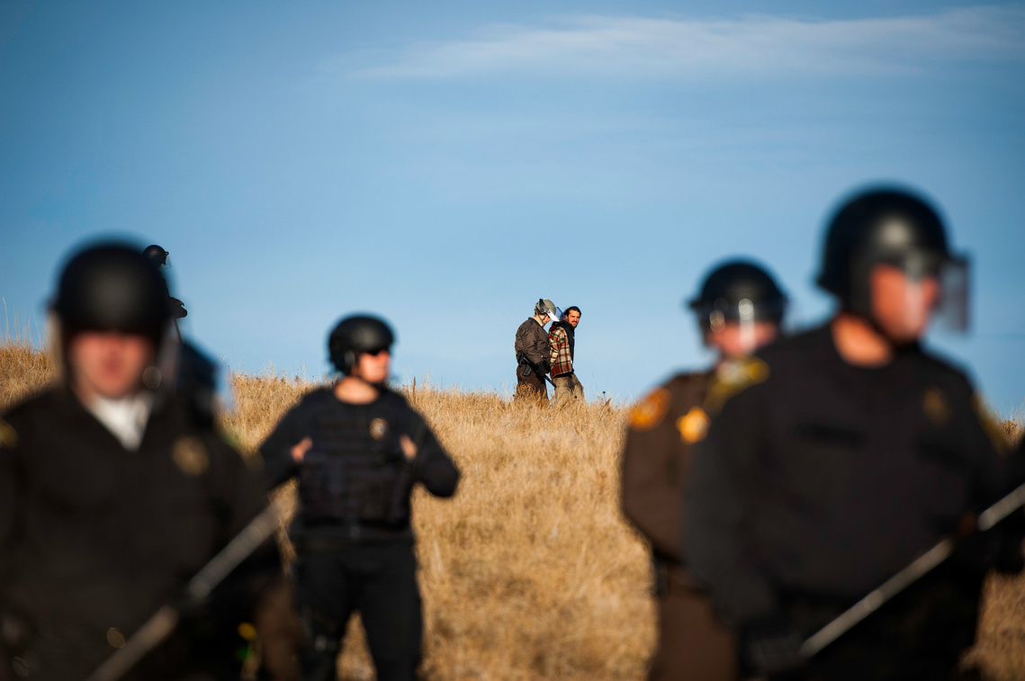 A man is taken into custody by North Dakota law enforcement during a peaceful protest Saturday, Oct. 22 near a Dakota Access pipeline construction site northwest of Cannon Ball, N.D.