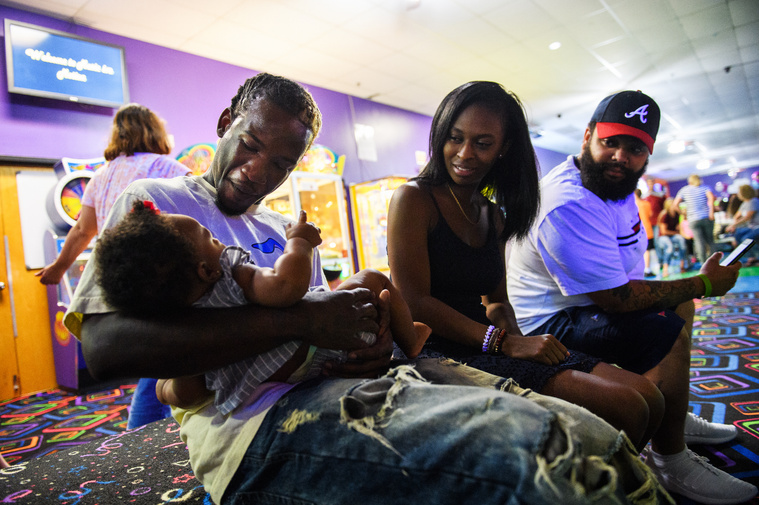 Isaih Kinloch holds Oakland Rae Patrick as he hangs out with Jordyn Patrick and Dominique Mccants at Music In Motion Family Fun Center in Summerville for his son's birthday party on Saturday, July 29, 2018.