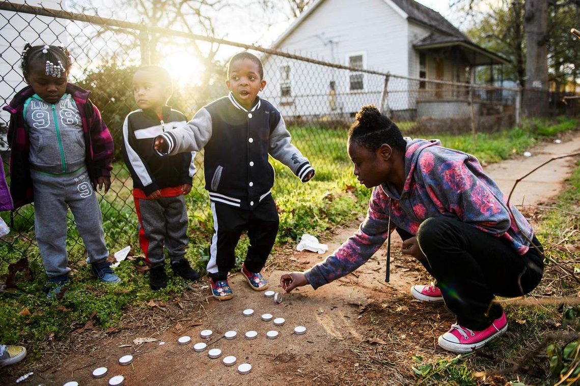 Brittany Debose, 22, lays down candles to spell out 