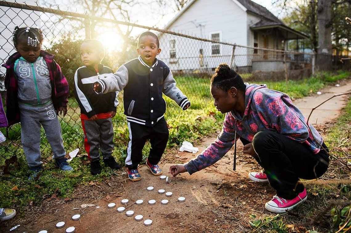 Brittany Debose, 22, lays down candles to spell out 