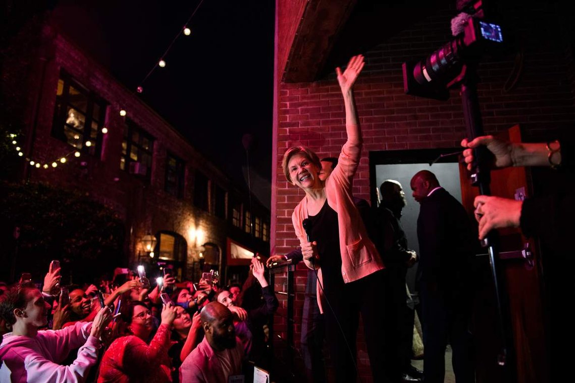 Democratic presidential candidate Elizabeth Warren waves to a crowd of supporters who weren't able to attend her rally at the Charleston Music Hall because it was at capacity Wednesday, Feb. 26, 2020.