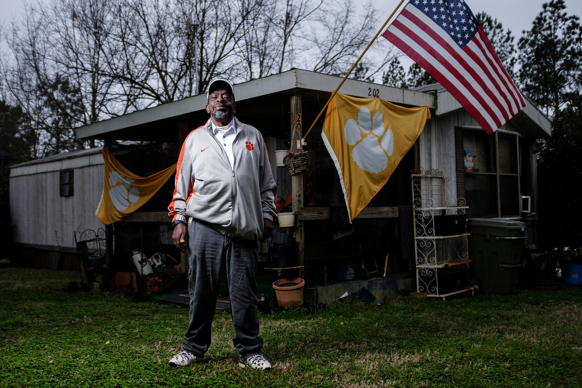 Danny L. Cannon, 63, stands in front of his home in the Calhoun neighborhood in Clemson, S.C. Cannon is a diehard Clemson football fan, but he and his neighbors have been feeling increased pressure from living less than two miles from the university. 