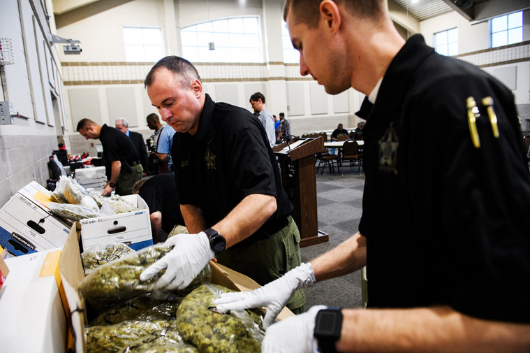 Spartanburg County Sheriff's Office deputies unpack seized marijuana and other contraband to show off to local media for a press conference on the success of Operation Rolling Thunder on Friday, May 4, 2018.