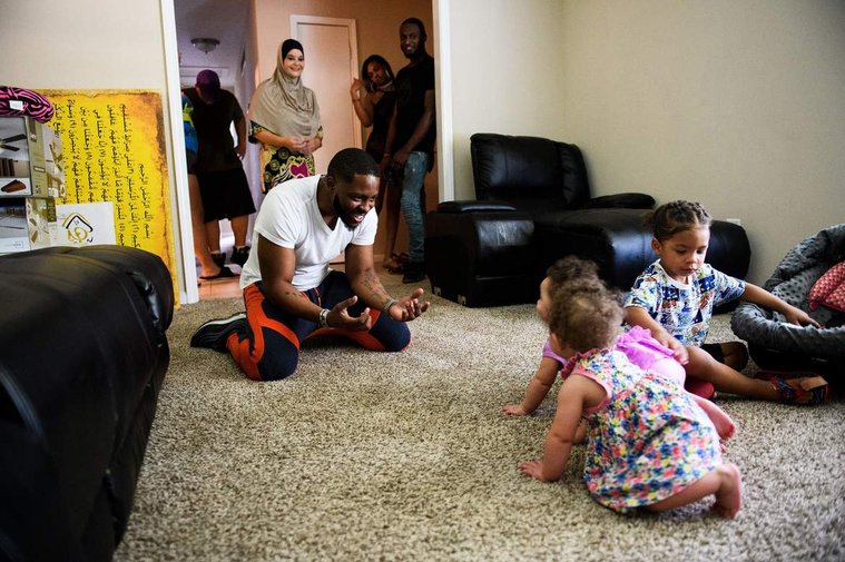 Johnnie Grant plays with his twin daughters, Alayna and Raynaon, and his son Yahya, 2 before heading to a music festival to perform in Atlanta June 30, 2018. 