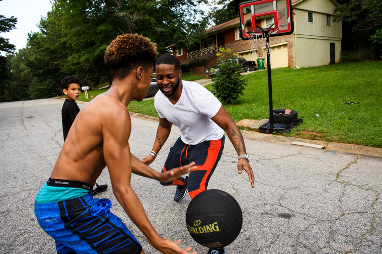 Johnnie Grant plays basketball with his son Da'Shawn and stepson Malachi on Saturday, June 30, 2018.