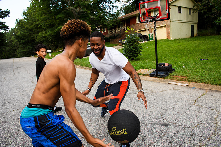 Johnnie Grant plays basketball with his son Da'Shawn and stepson Malachi on Saturday, June 30, 2018.