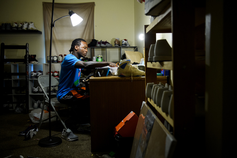 Isaih Kinloch cleans, restores and customizes shoes as a side hustle in his home on Sunday, July 29, 2018.