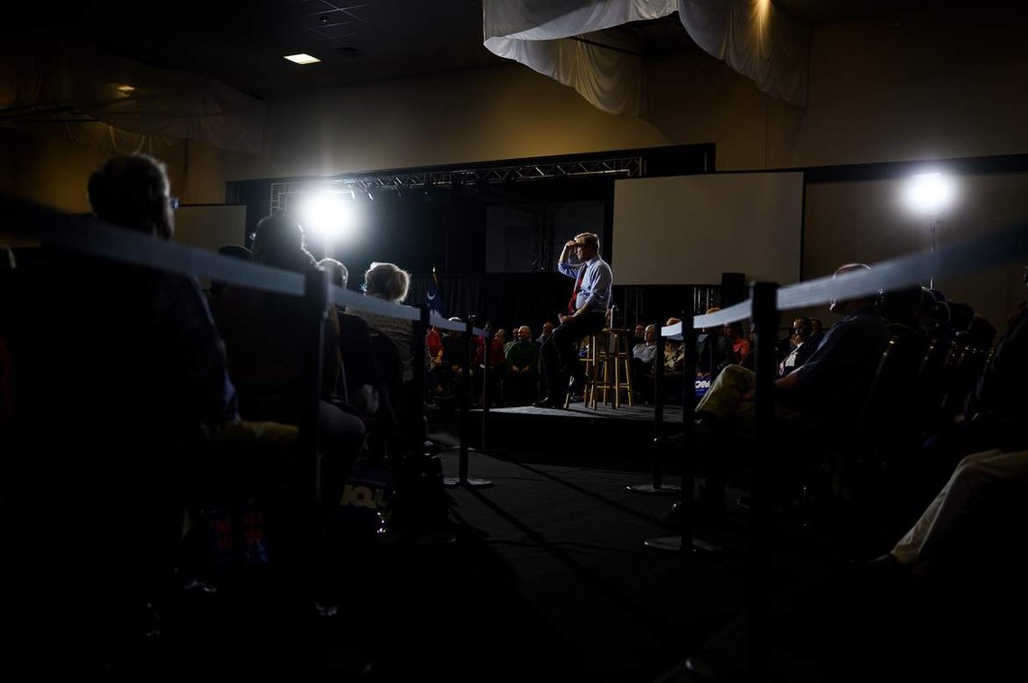 Democratic presidential hopeful Tom Steyer covers his eyes from the bright lights as he campaigns at the West End Community Development Center Monday, Feb. 17, 2020.