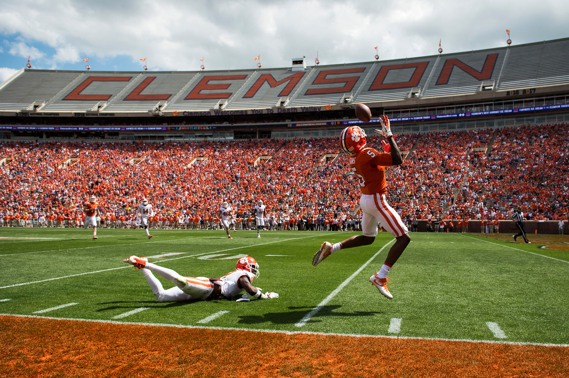 Clemson wide receiver Tee Higgins (5) evades cornerback Mark Fields (2) to catch the ball and score a touchdown during the 2018 spring football game on Saturday, April 14, 2018.