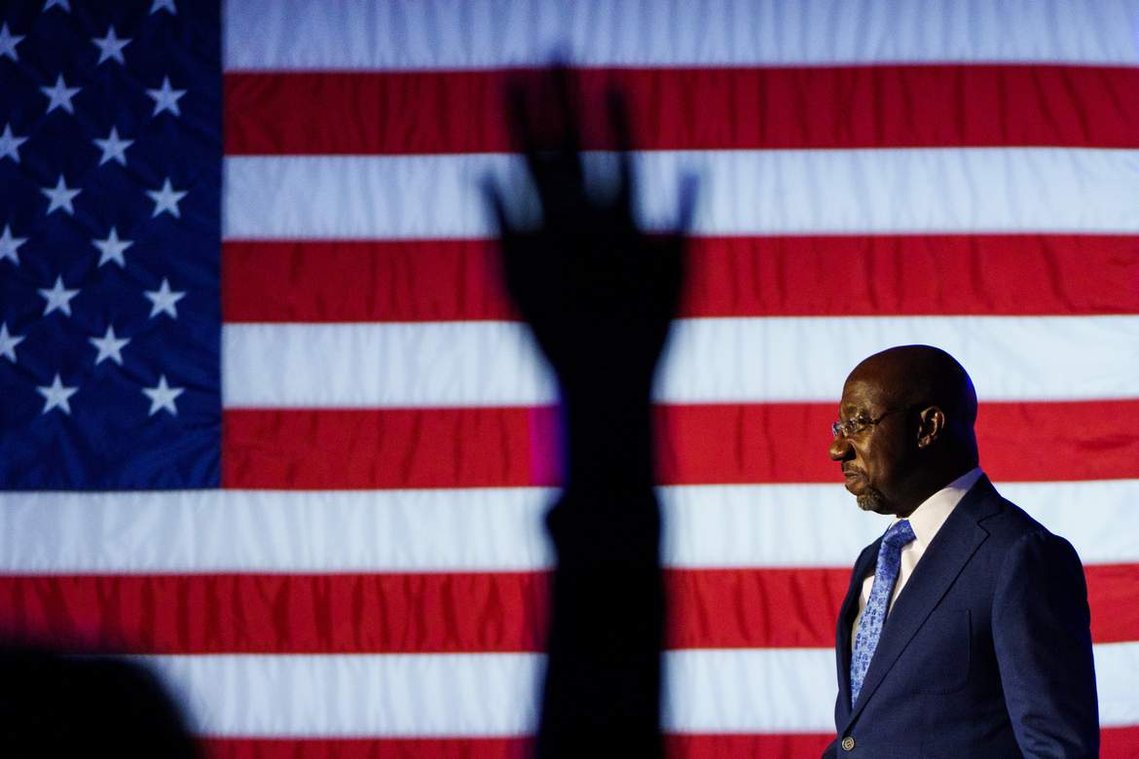 Sen. Raphael Warnock walks on stage to address his supporters on the tight race against Republican challenger Herschel Walker during his election night watch party in Atlanta Tuesday, Nov. 8, 2022.
