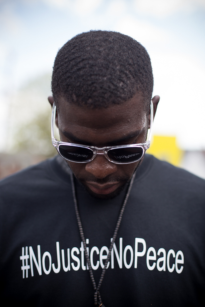Darius Gordon bows his head during a break from marching.