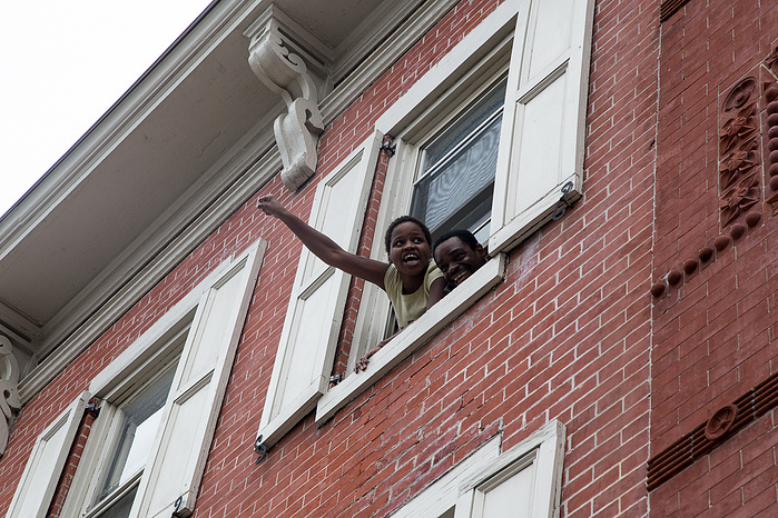 Locals raise their fists in support as marchers travel through Trenton, New Jersey.
