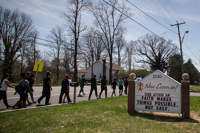 Marchers pass by a church in Harford County, Maryland.