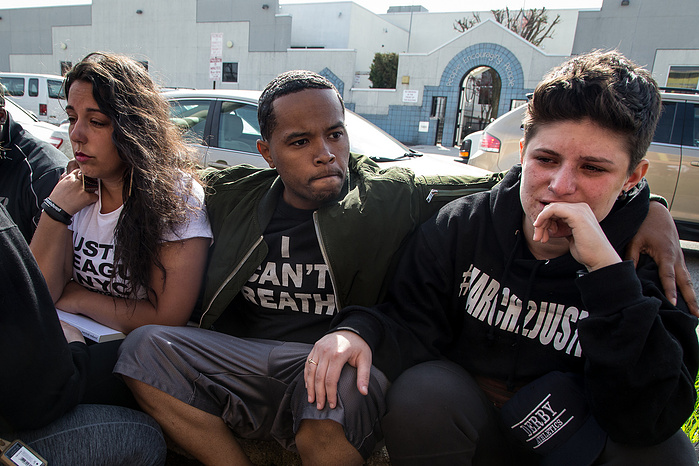 Marchers react to the sudden news of Freddie Gray's death.